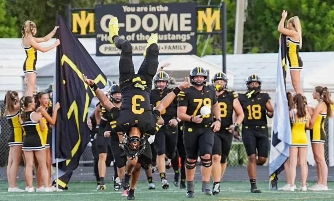 Merritt Island football players enter the field in black and yellow uniforms before a September game.