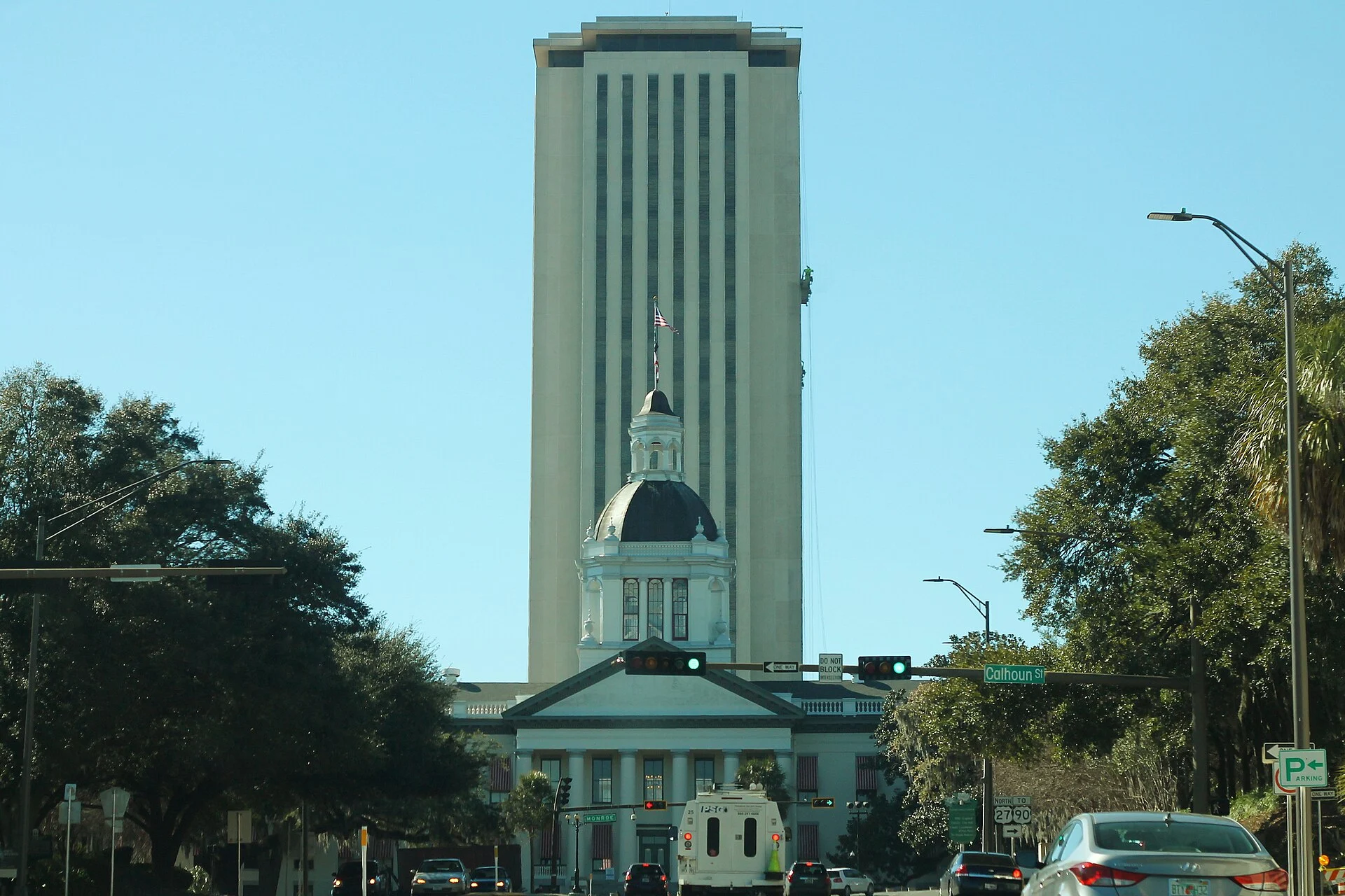Florida Capitol tower behind the historic Capitol dome, viewed along a Tallahassee street in 2015.