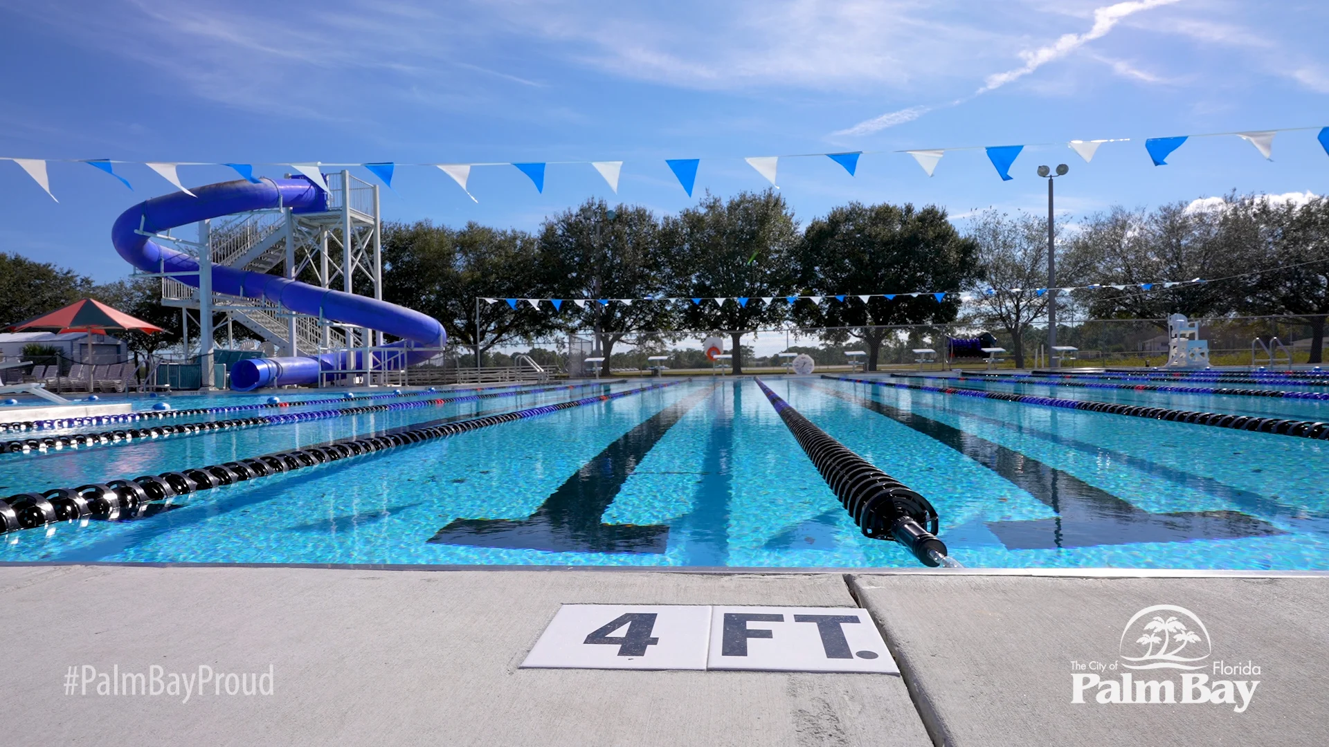 Swim lanes and a blue waterslide at the Palm Bay Aquatic Center.