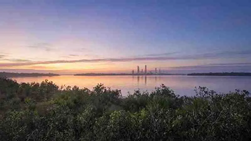 Sunrise over the Indian River Lagoon with launch towers on the horizon